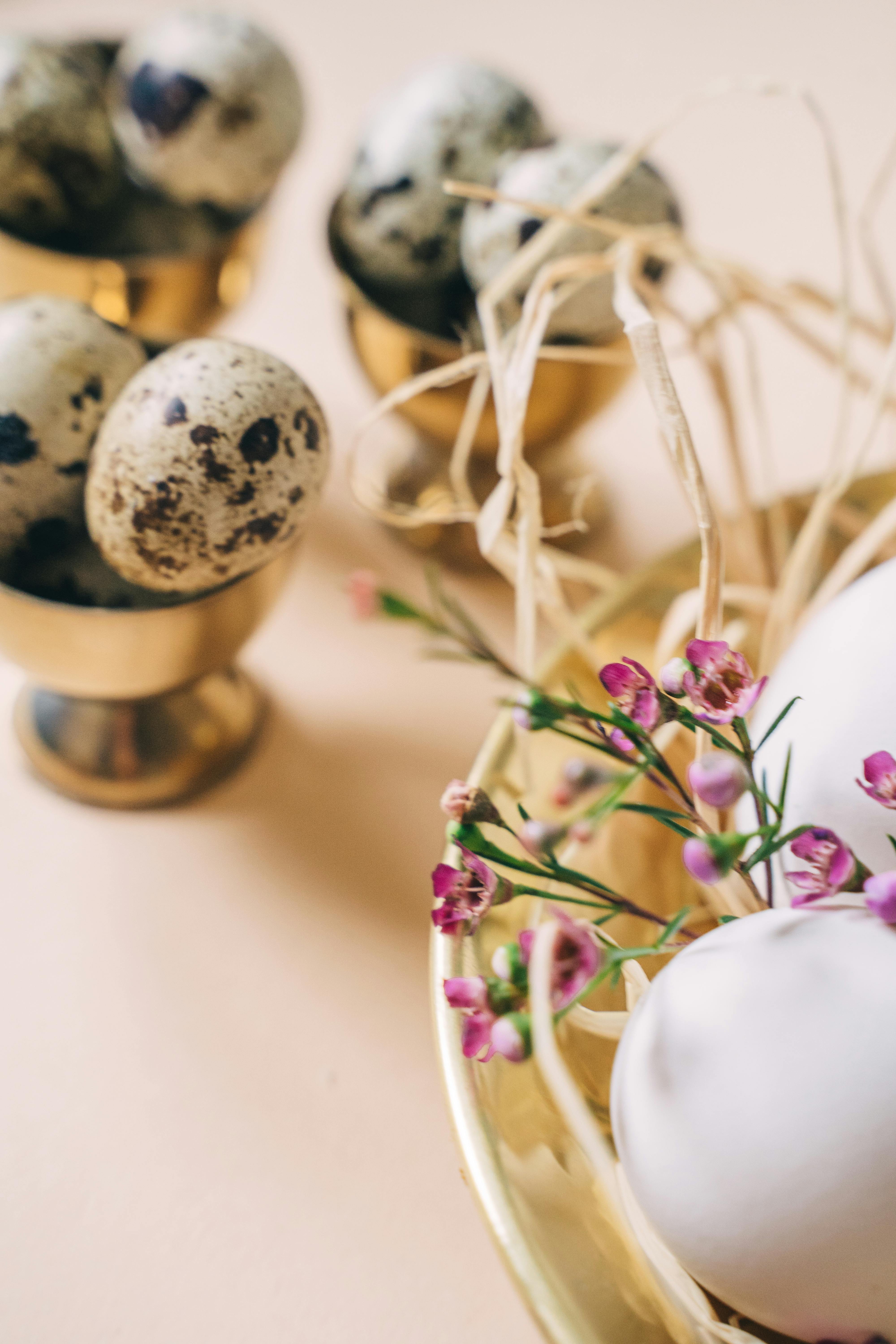 quail eggs on golden egg holder