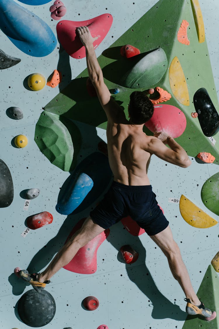 Muscular Man Wall Climbing