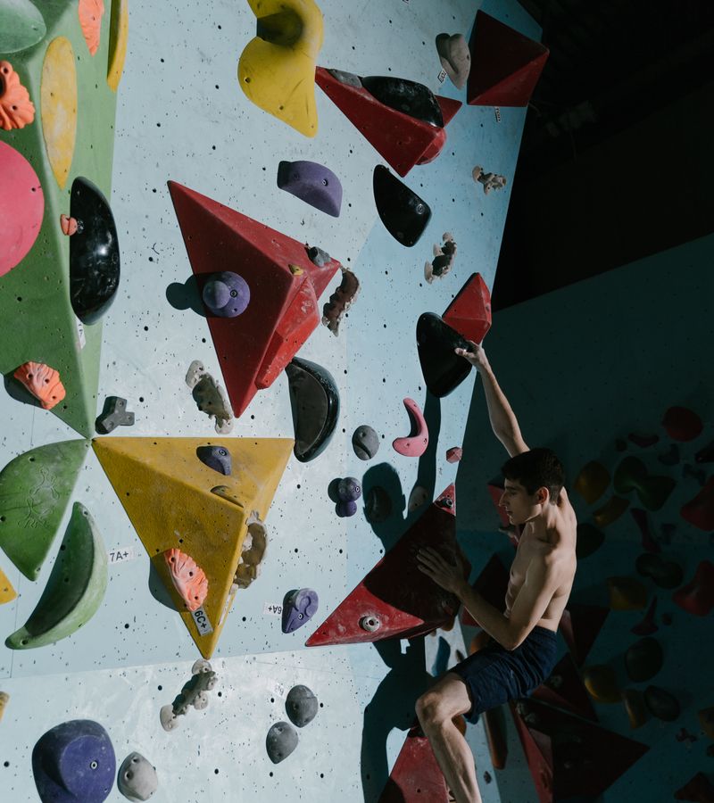 A close-up of a climber's hands and chalk