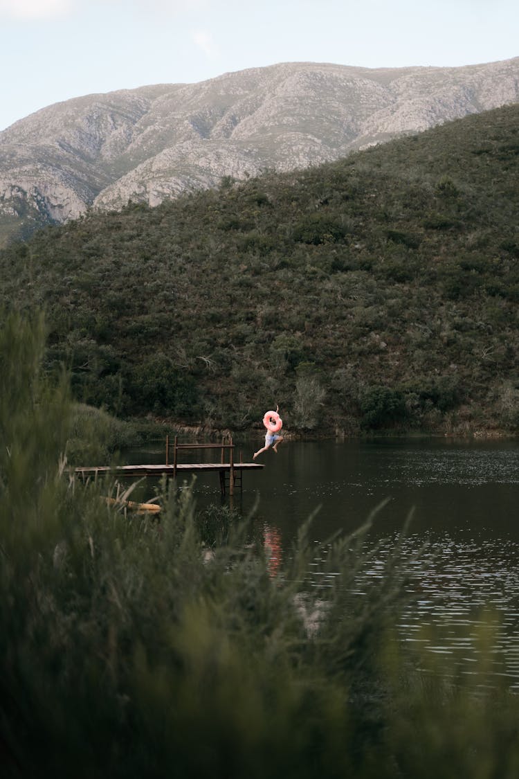 Person Jumping Into The Lake