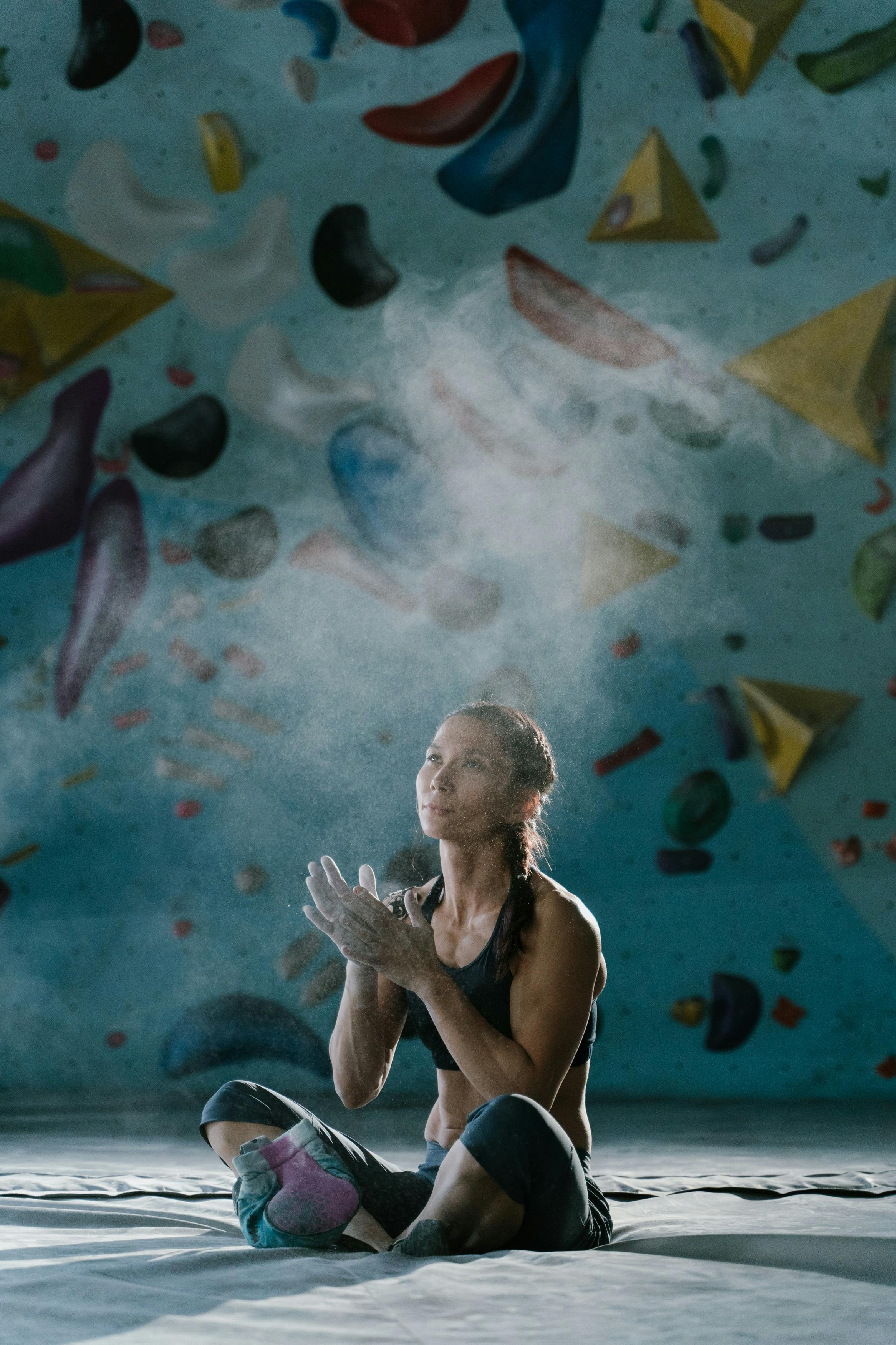 a woman in black crop top sitting on a soft floor