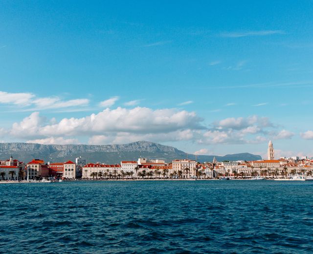 Discover the picturesque coastal cityscape of Split, Croatia, with its charming harbor and mountain backdrop.