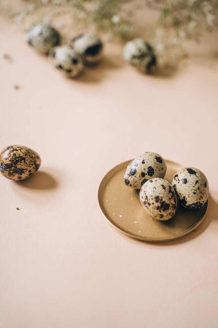 Quail Eggs On A Round Brown Coaster