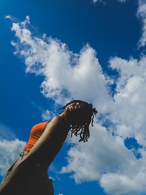 Low Angle Shot of a Woman in Orange Top