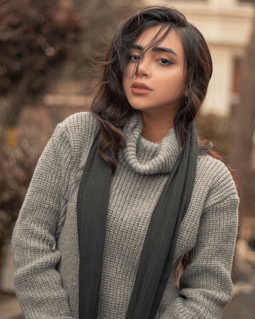 Beautiful Girl in a Gray Knitted Sweater Looking at the Camera