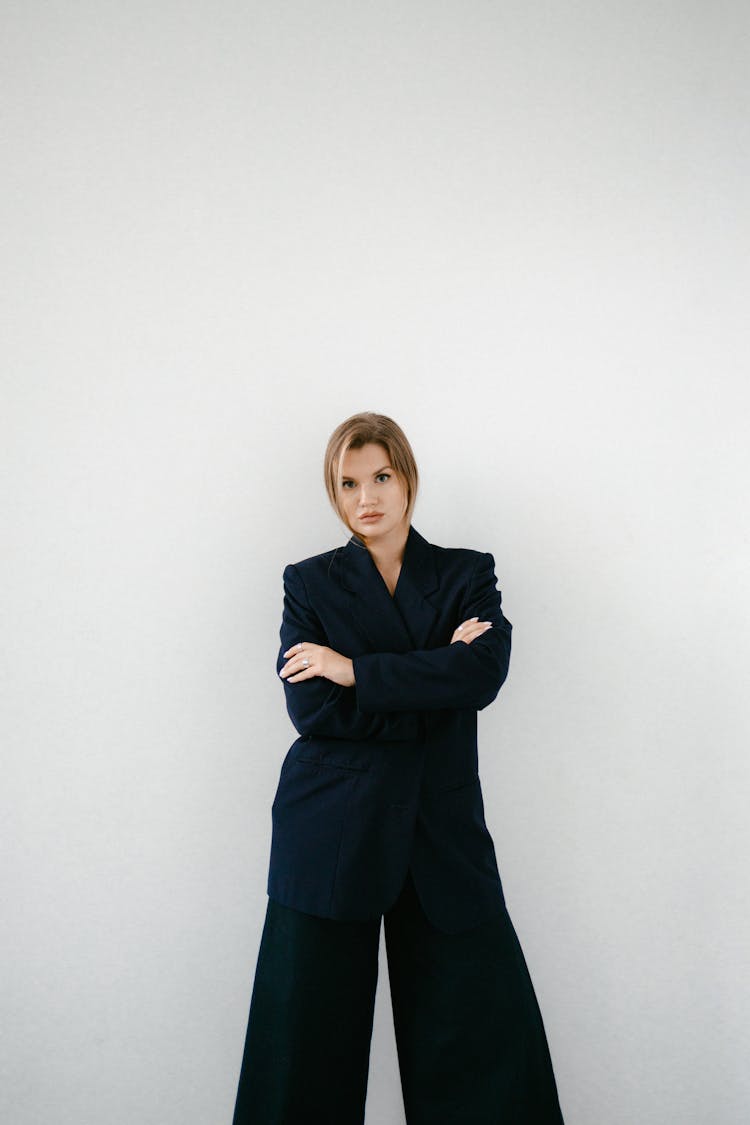 Woman In Black Blazer Standing With Arms Crossed