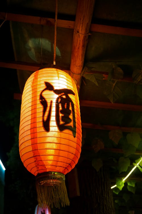 A Hanging Lighted Orange Paper Lantern