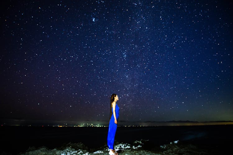 Anonymous Lady On Ground At Night Admiring Starry Sky