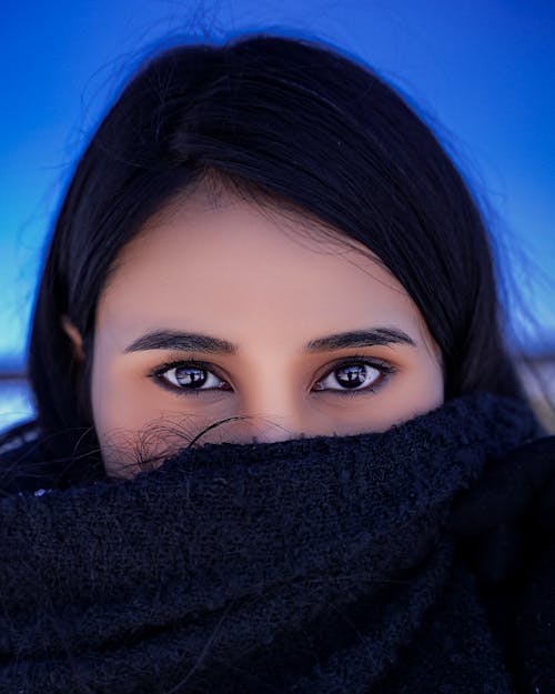 Woman Covering Her Mouth With Black Scarf