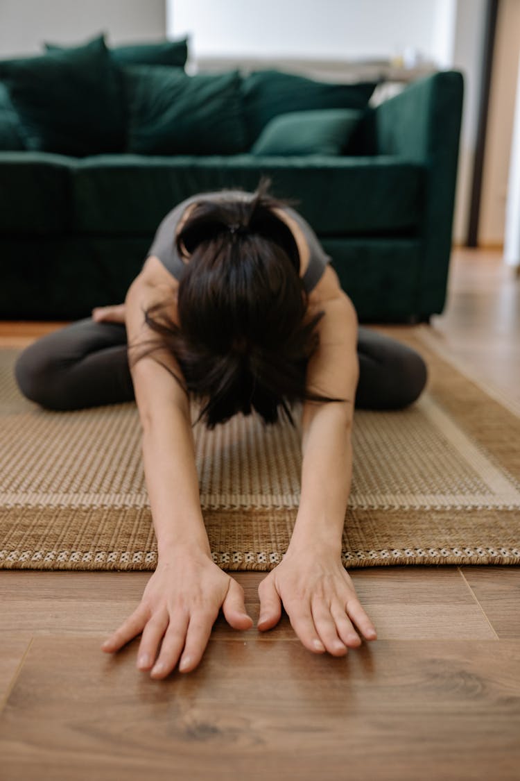 Woman Sitting On A Rug While Meditating