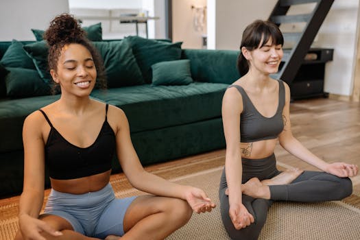Two women enjoying a relaxing home yoga session, promoting health and mental well-being.