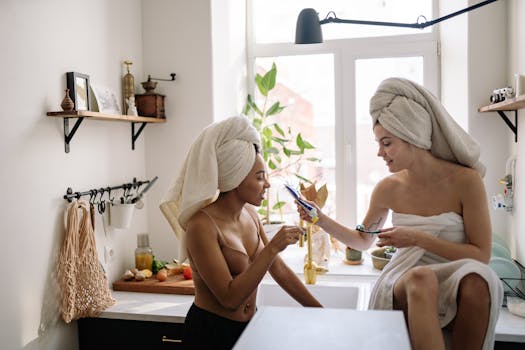 Two women in towels enjoy a joyful morning routine, highlighting self-care and friendship.