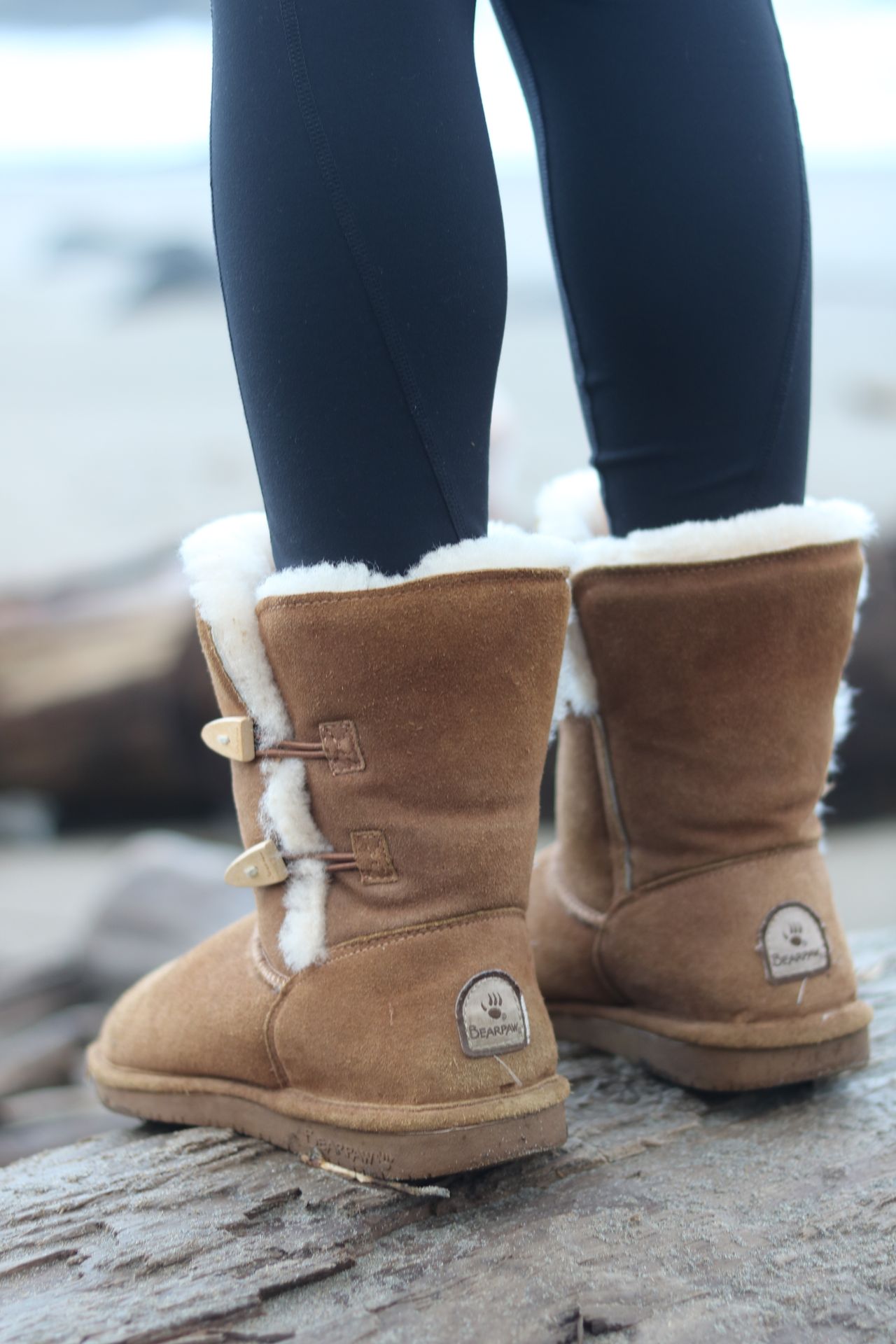 Black leggings paired with tan shearling boots