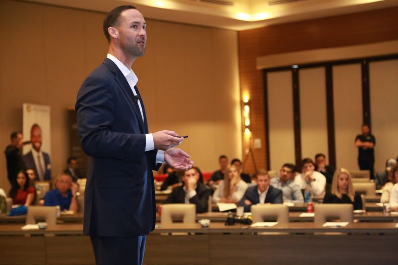 Coach speaking to a room of founders, photo by Jeremy McGilvrey on Pexels