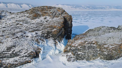 Rocks on a Frozen Coast Covered in Snow 