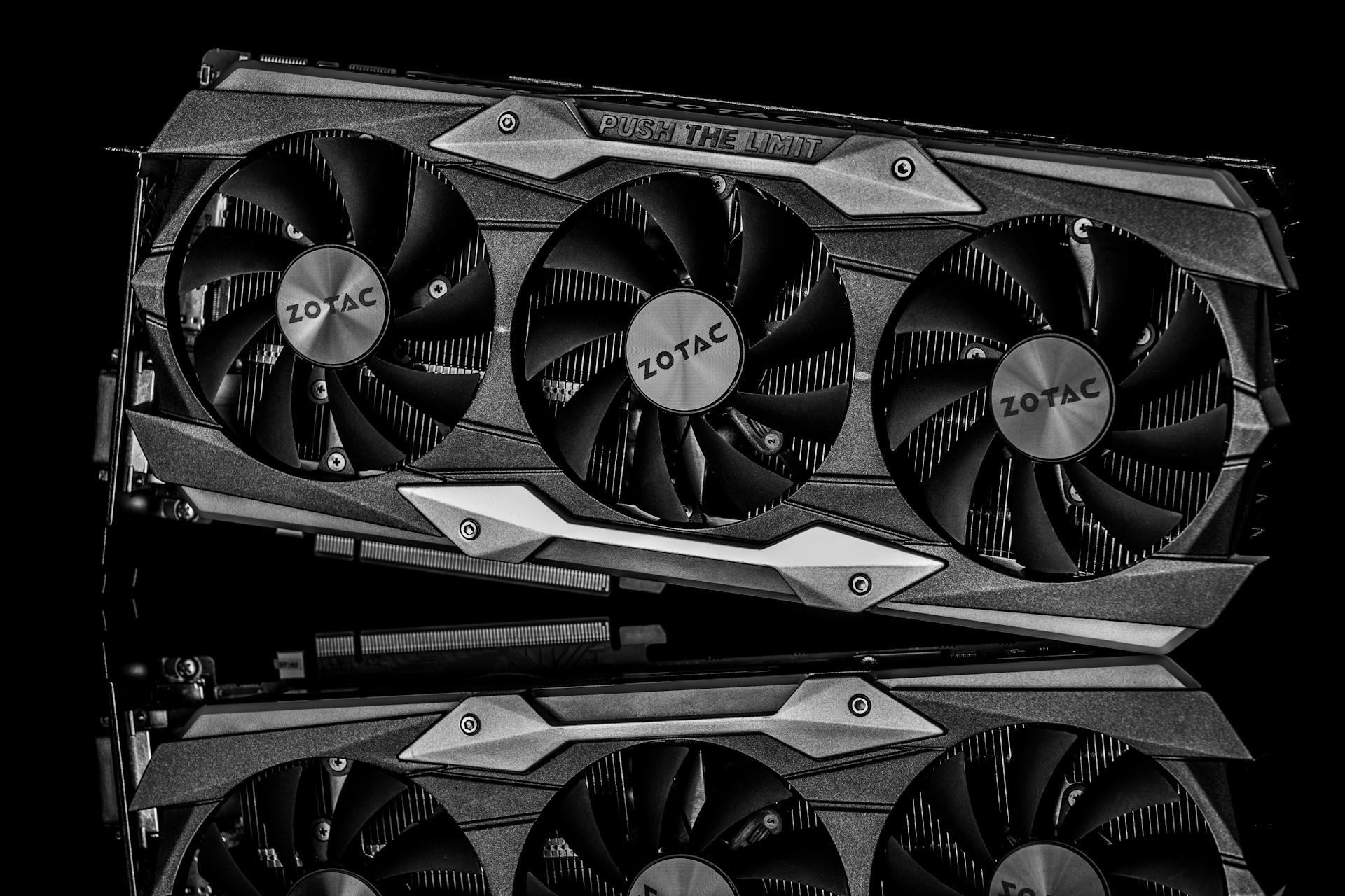 Black and white image of a graphics card with technology theme and metal reflection.