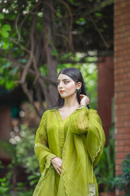 A Woman in Green Long Sleeve Dress