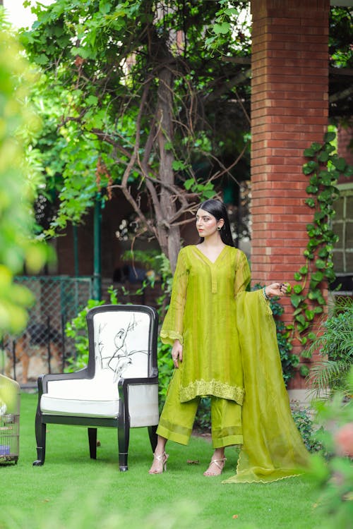 Young Smiling Woman Wearing Yellow Sari and Pink Choli Blouse