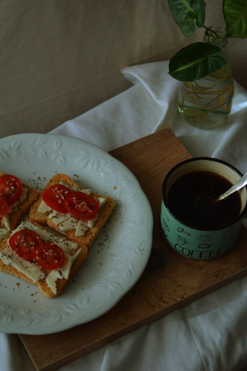 Free Close-up of tomato and cheese toast with coffee, an ideal breakfast setting. Stock Photo