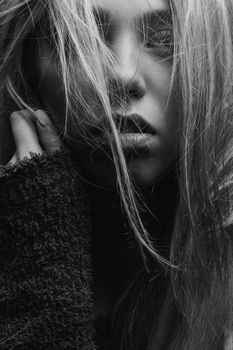 Dramatic black and white close-up portrait of a woman with expressive eyes.