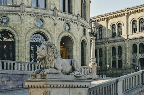 Gray Lion Statue Near Grey Concrete Building
