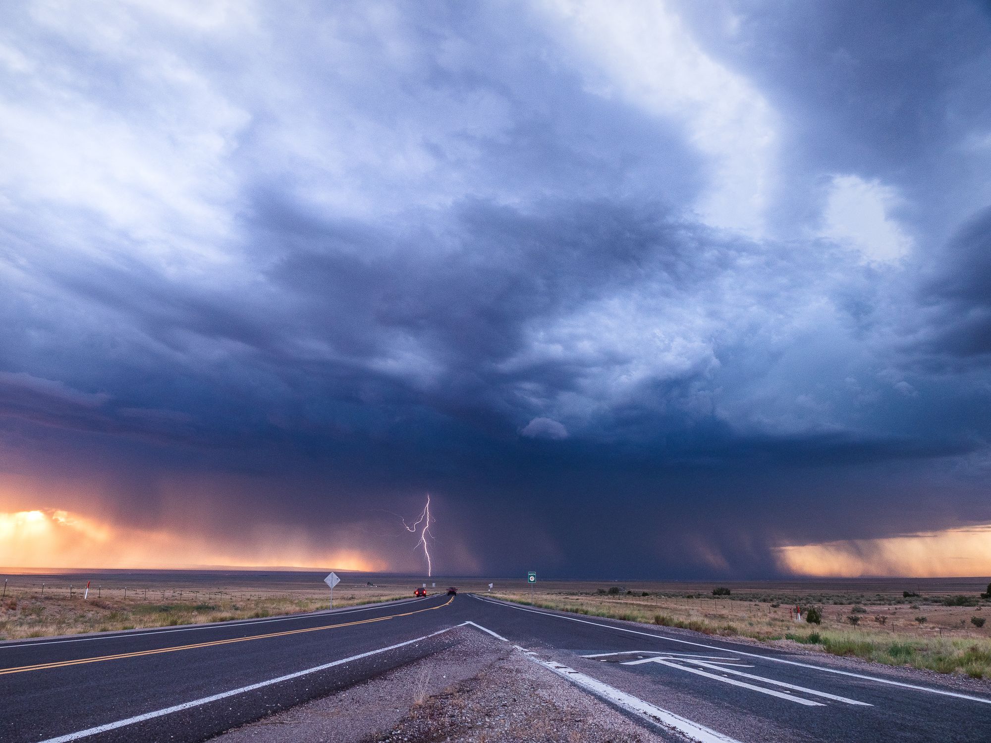 Powerful thunderstorm with lightning over a desert highway in New Mexico, USA.