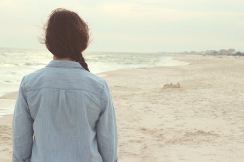 Woman Standing on Shore during Daytijme