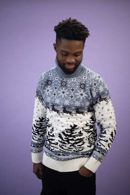 A Man in Christmas Sweater and Black Pants