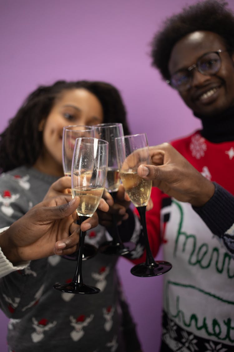 People Toasting Champagne On Christmas Party