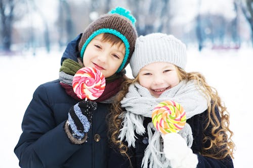 Girl and Boy Holding a Lollipop 