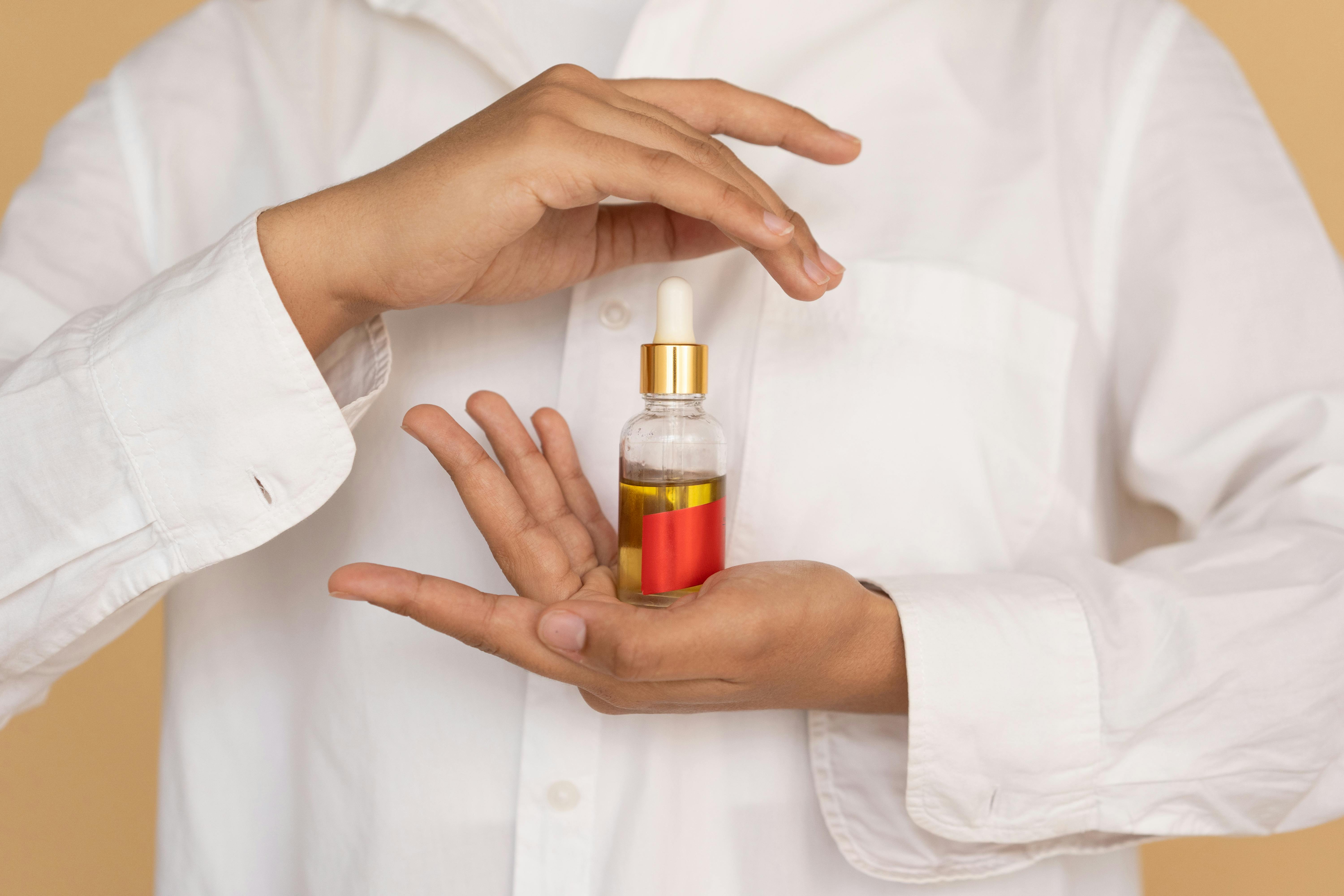 woman holding a bottle of essential oil