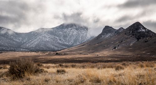 Free Peaceful winter landscape featuring snow-dusted mountains near Fallon, NV. Stock Photo