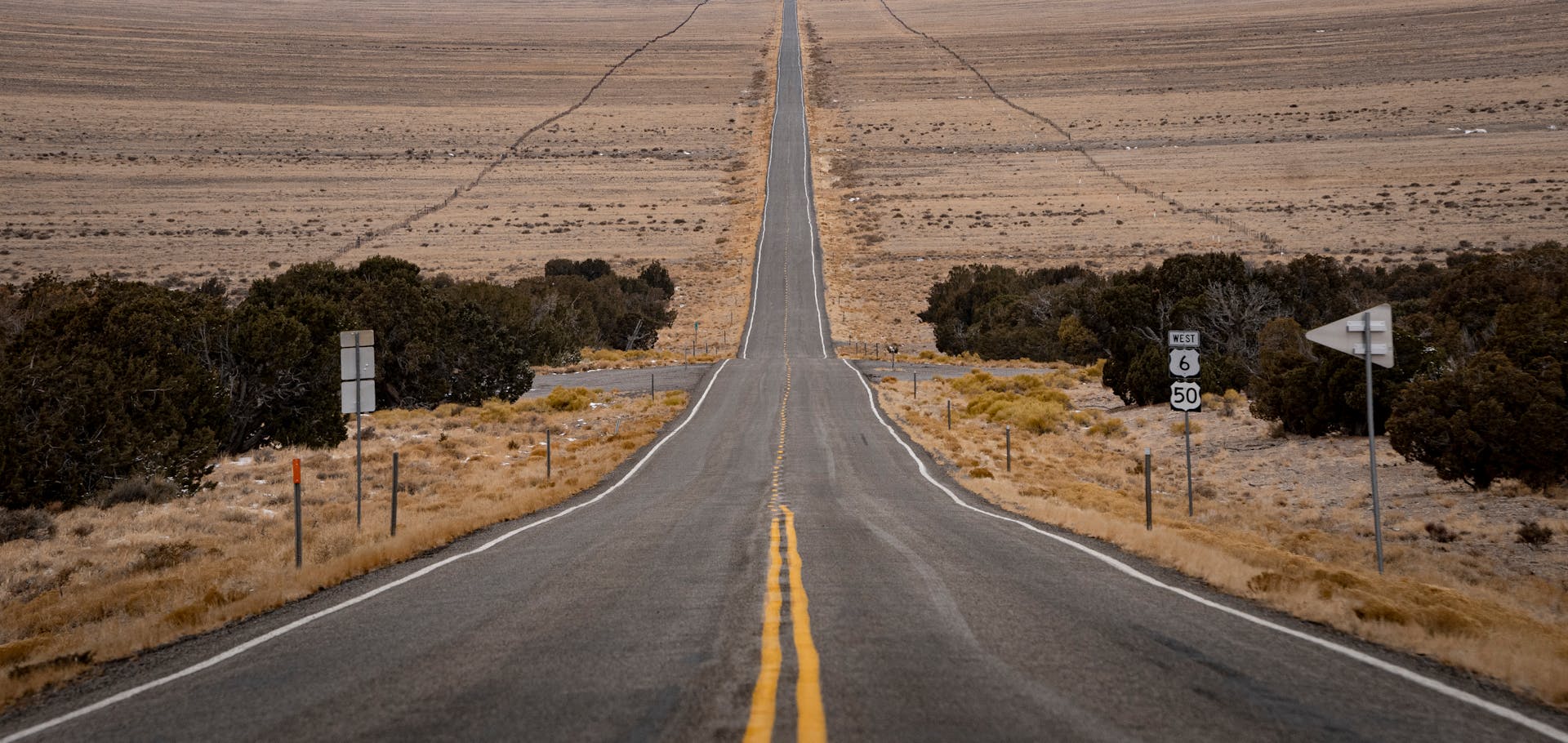 A straight, scenic road through the desert of Fallon, Nevada, showcasing vast open landscapes.