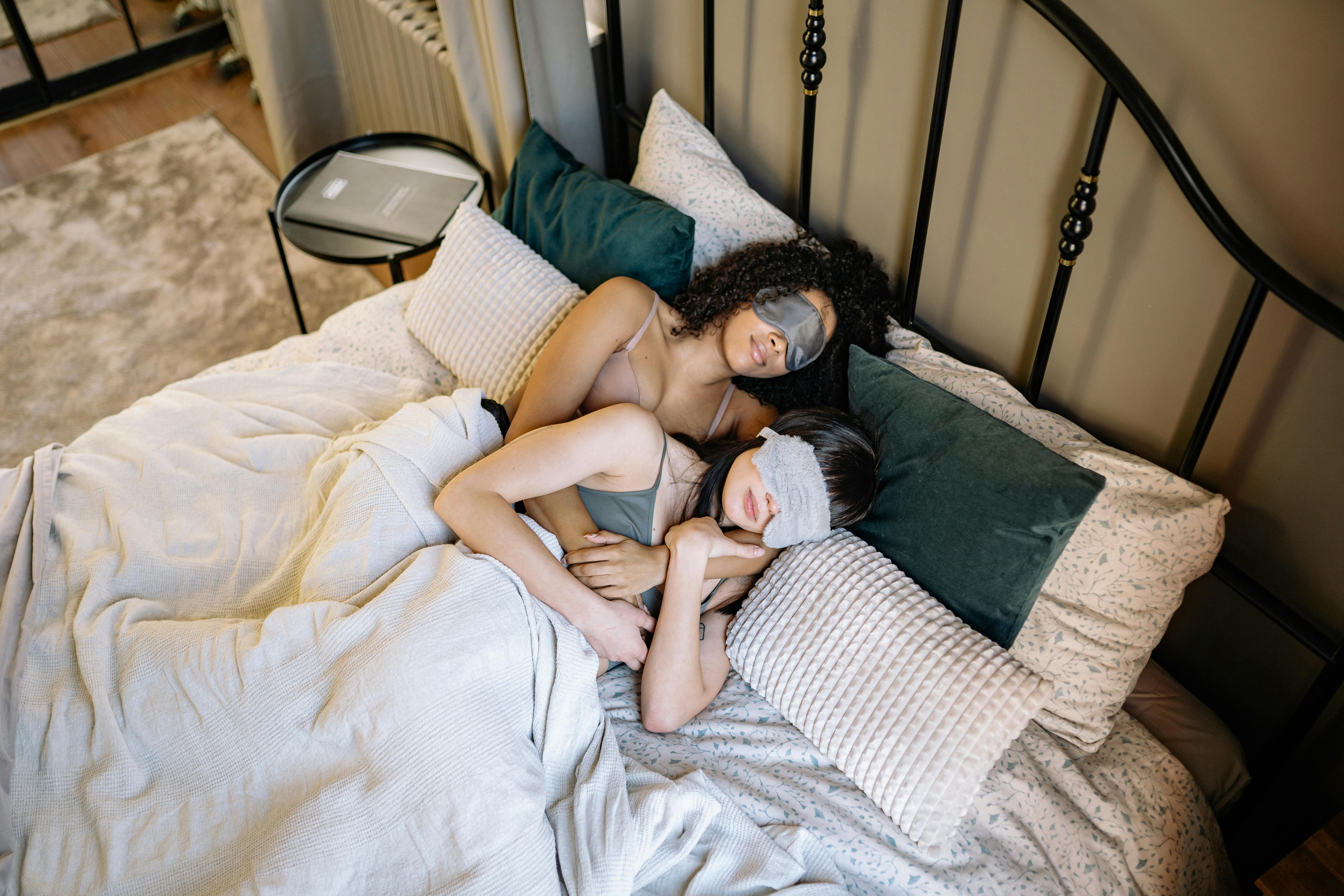 a couple sleeping together while wearing sleep mask