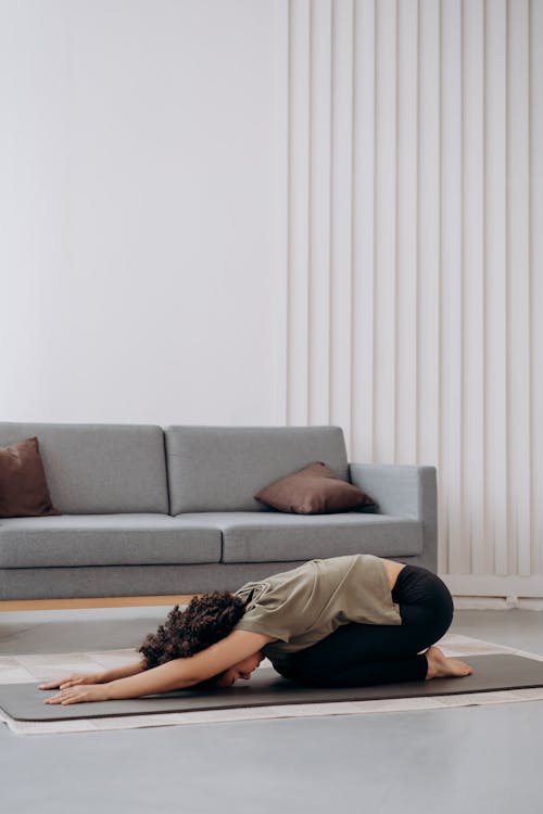 Free Woman in Brown Shirt In A Bending Position Stock Photo