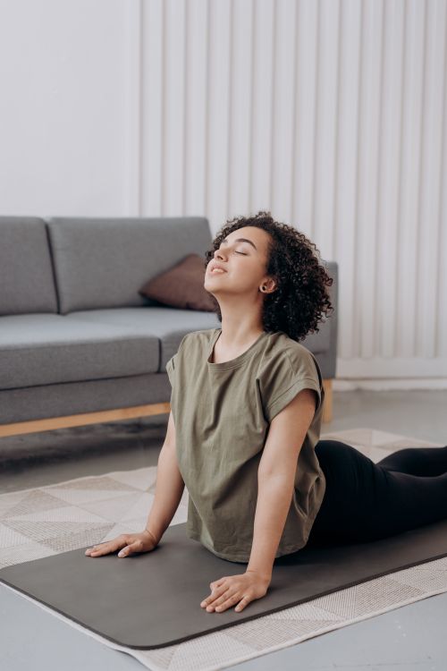Free Young woman performing yoga indoors, focusing on balance and relaxation. Stock Photo