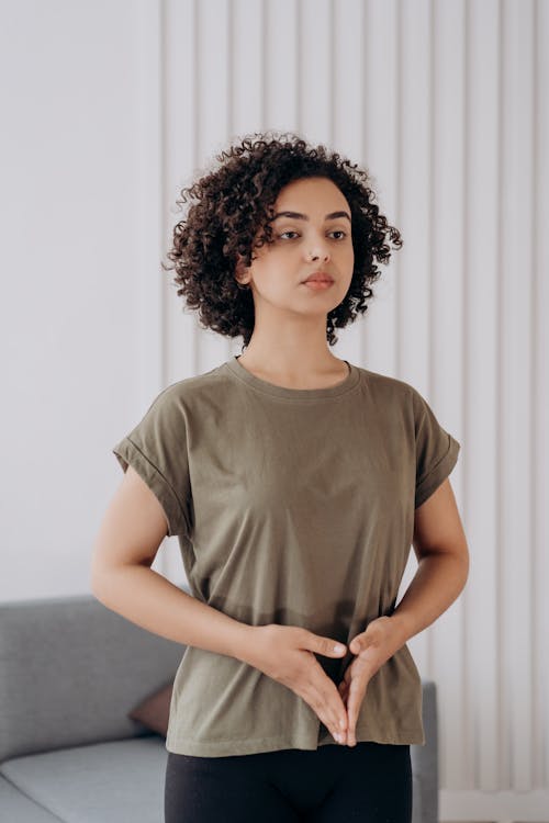 Free Woman in Gray Crew Neck T-shirt Standing In Yoga Position Stock Photo