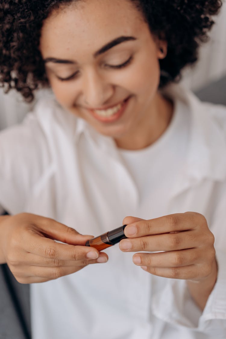 A Person Holding A Cosmetic Product