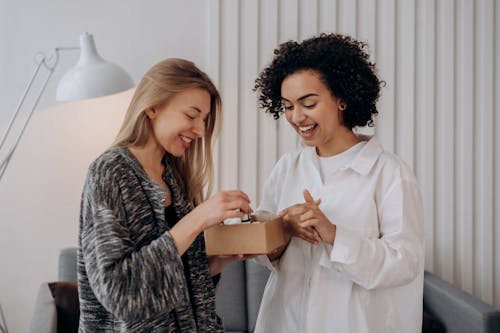 Free Two Women Enjoying A Box Of Beauty Products Stock Photo