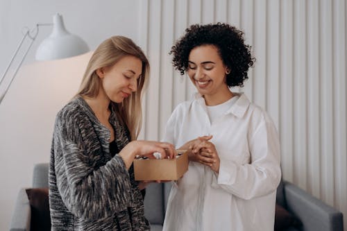 Free Two Women Checking On A Box Of Essential Oils Stock Photo