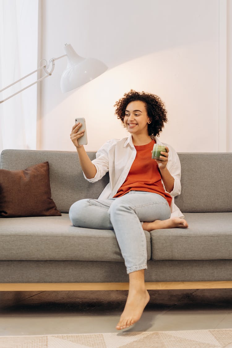 Woman Taking Selfie While Holding A Glass Of Fresh Drink