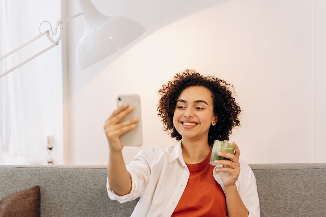 Free Woman Taking Selfie While Drinking A Fresh Smoothie Stock Photo