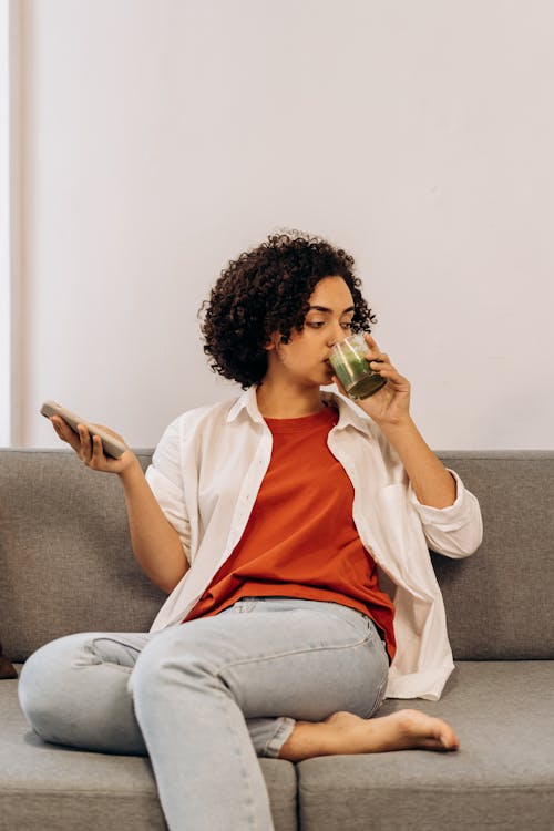 Woman Drinking A Glass Of Fresh Smoothie