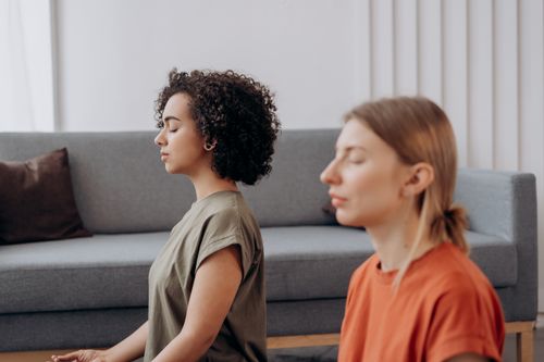 Free Two women practicing meditation in a serene indoor setting, fostering mindfulness. Stock Photo