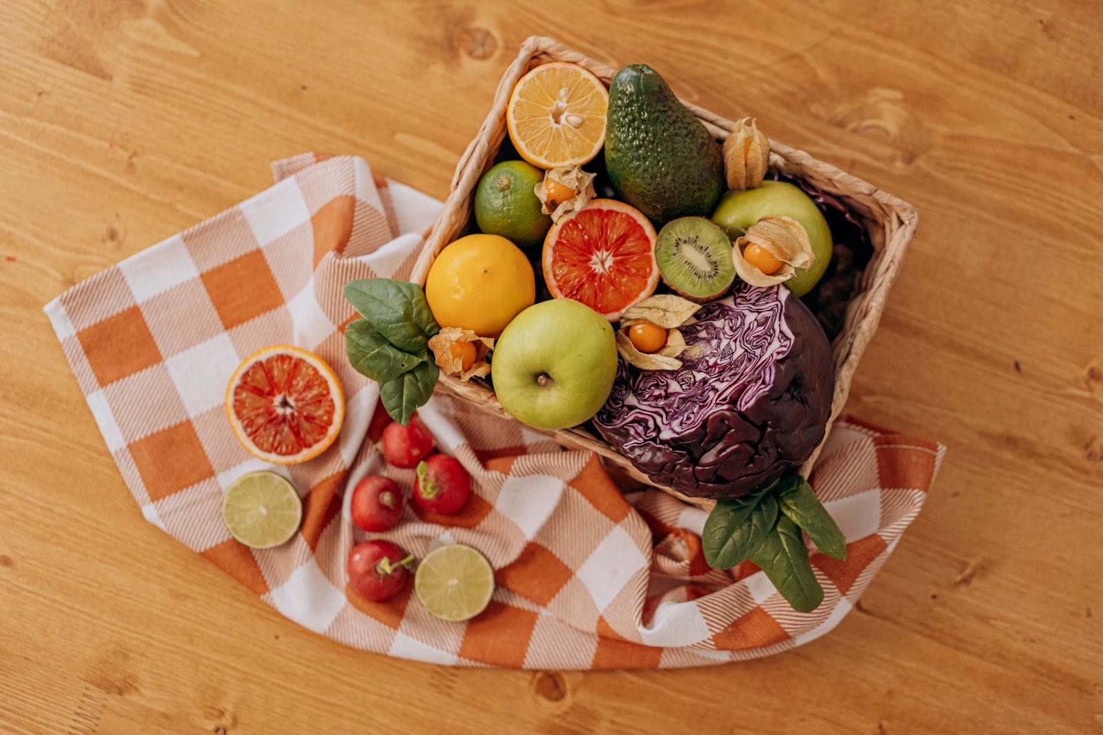 Basket of fruit and vegetables on a wooden table
