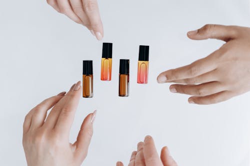 Free People Picking up Essential Oils in Bottles Stock Photo