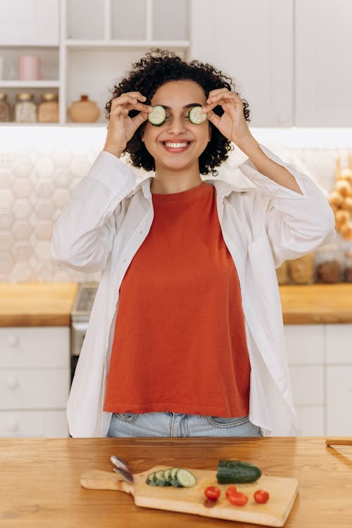 Woman With Slices Of Cucumber On Her Eyes