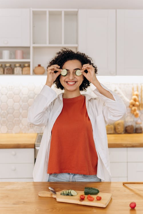 Woman Putting Slices Of Cucumber On Her Eyes