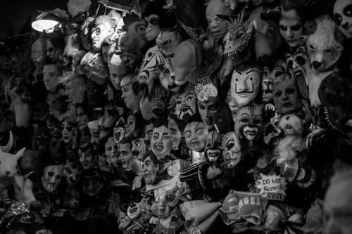 Free A haunting black and white photo of a collection of eerie masks, perfect for Halloween themes. Stock Photo