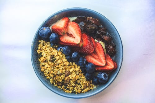 A Bowl of Fresh Fruit Breakfast on a White Surface